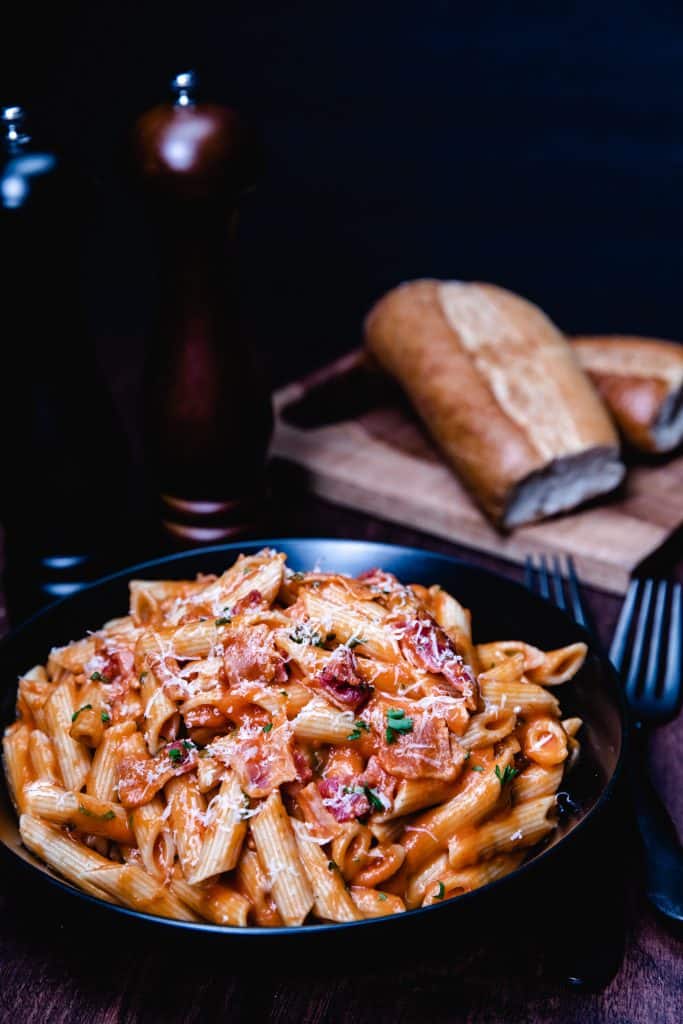 a bowl of tomato cream sauce on pasta.