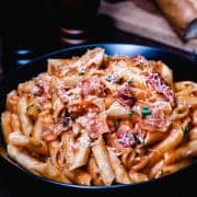 a bowl of tomato cream sauce over pasta