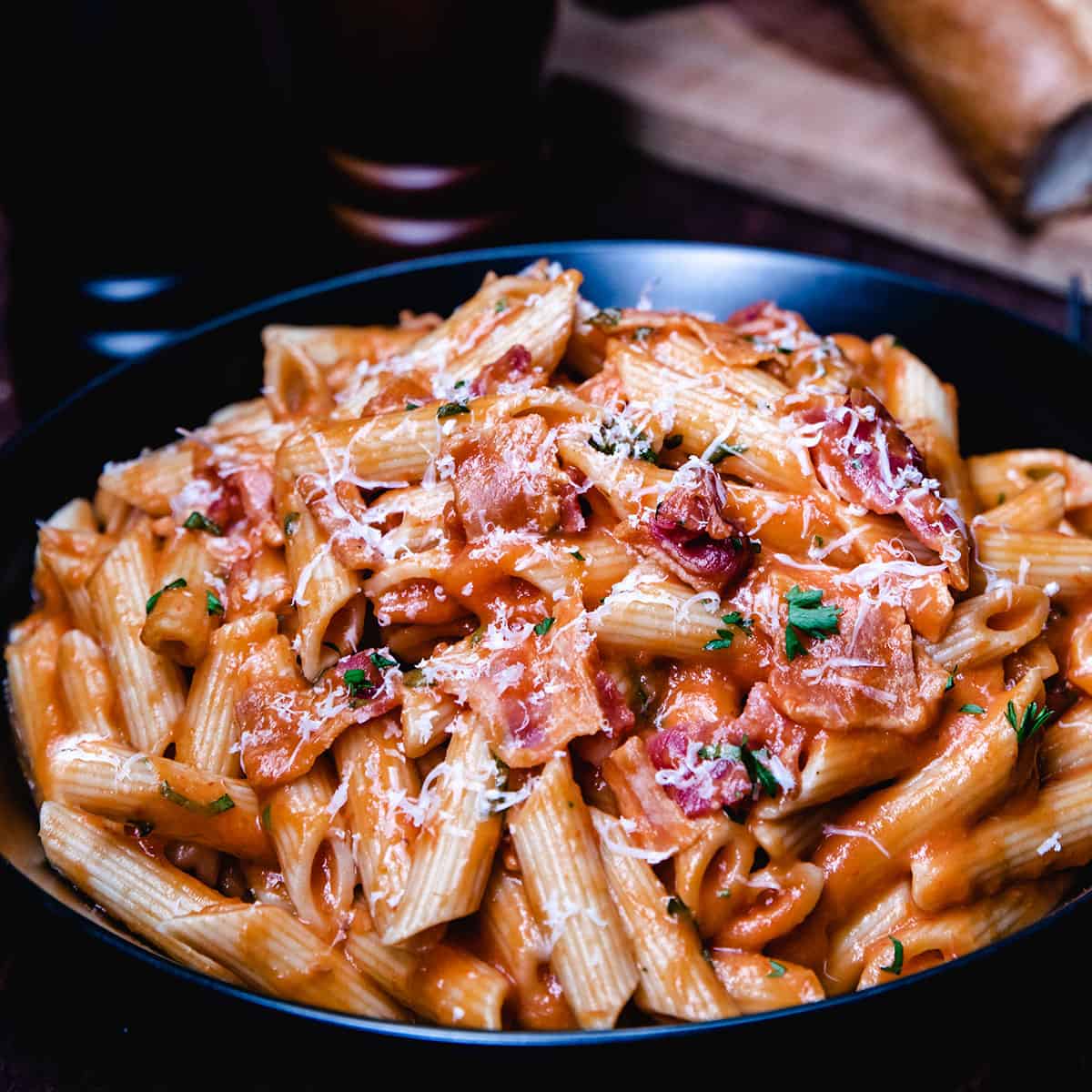 a bowl of tomato cream sauce over pasta