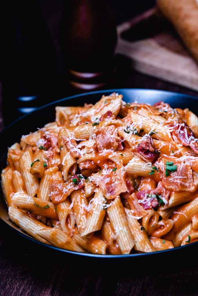 a bowl of tomato cream sauce on pasta.