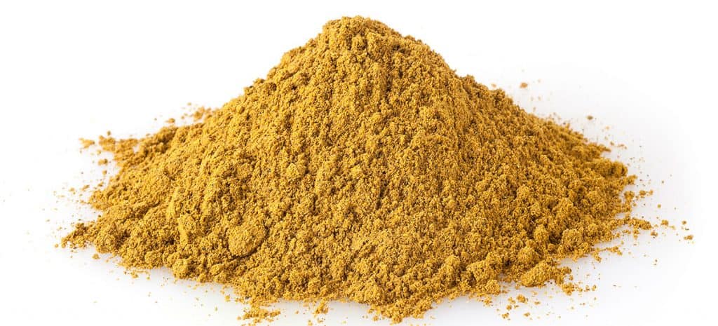 Heap of curry powder isolated on white background