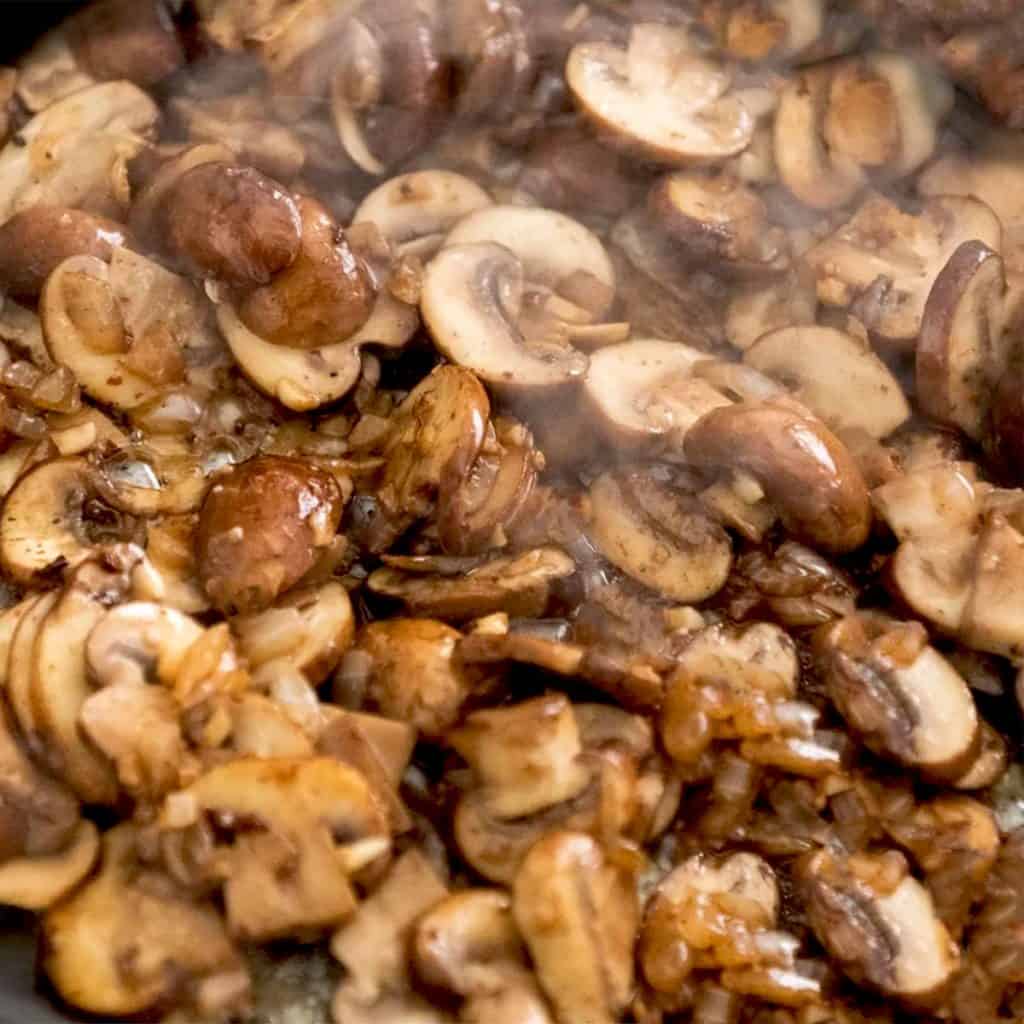 mushrooms cooking in a skillet