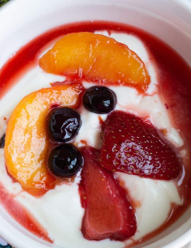 overhead picture of fruit compote with cream swirled in it