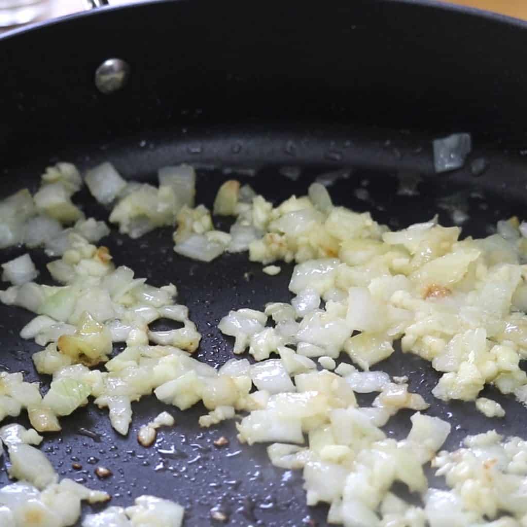 Onions and garlic cooking in a pan