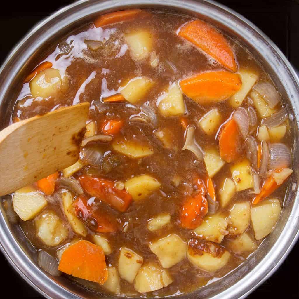 a put full of the cooked japanese curry with carrots and potatoes