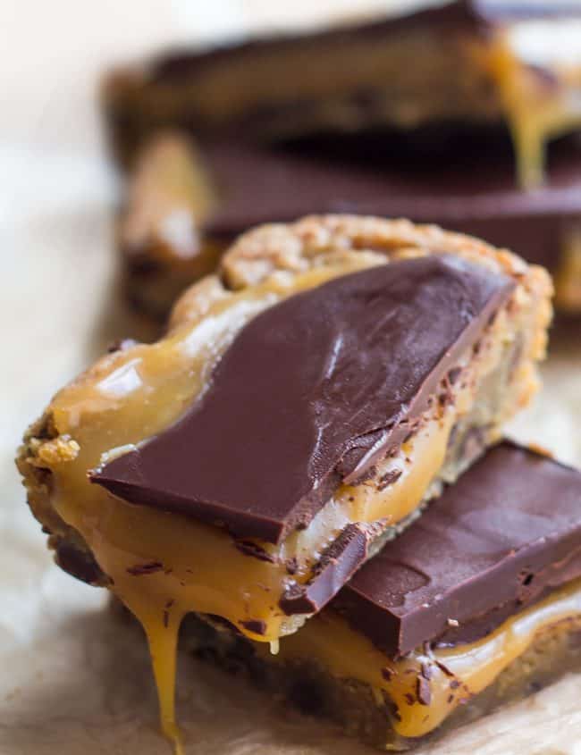 A plie of salted caramel blondies bars oozing with caramel