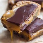 A plie of salted caramel blondies bars oozing with caramel