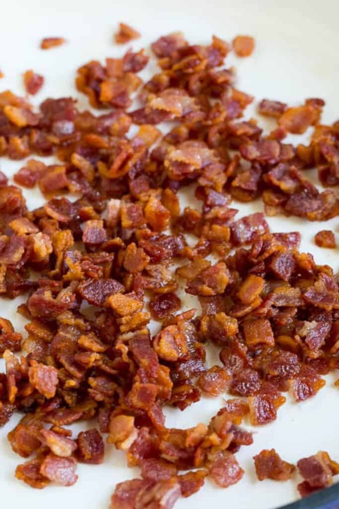 A pan with cooked, chopped bacon