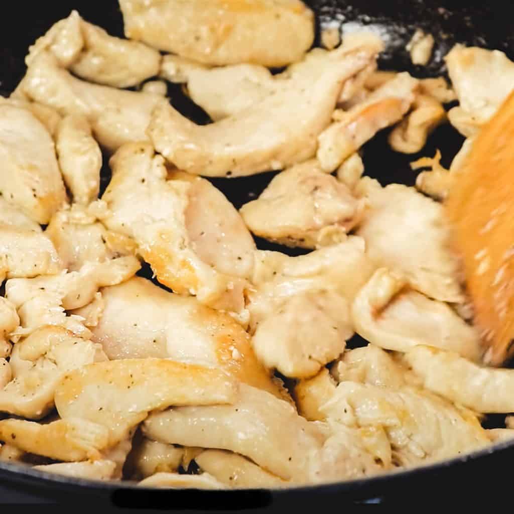 chicken being browned in a pan