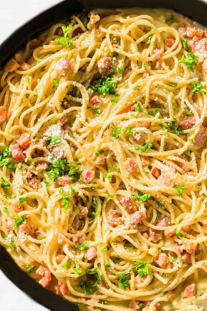 A pan of Spaghetti Alla Carbonara topped with parsley