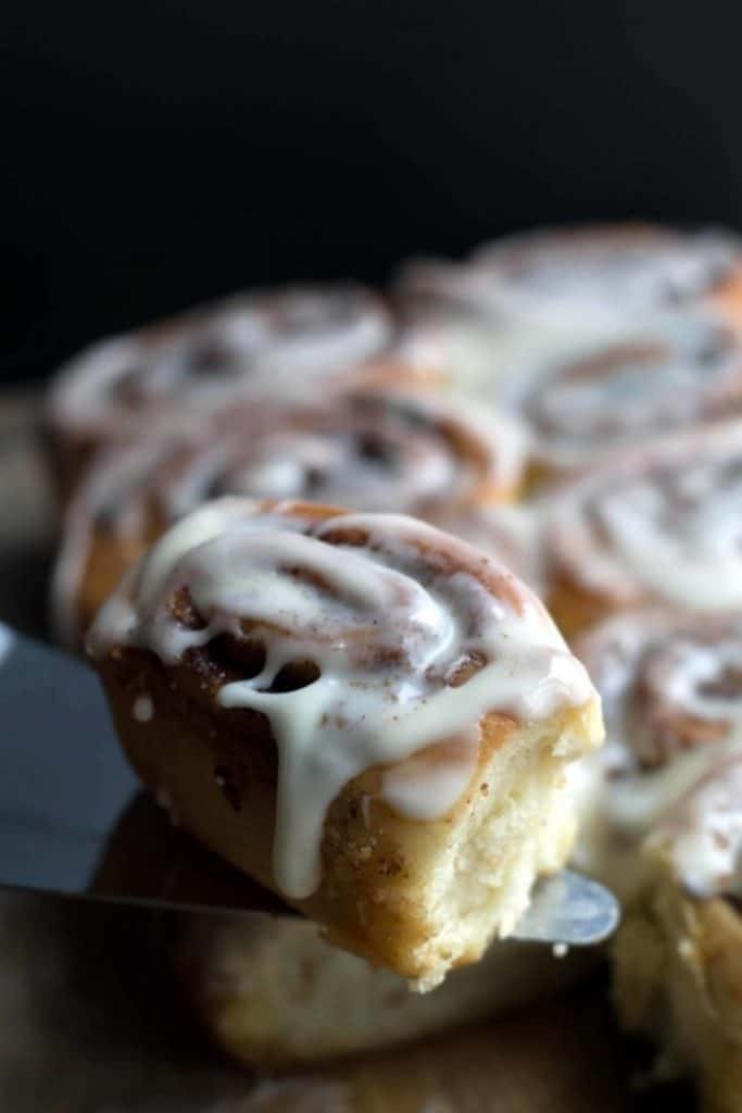 a cinnamon roll, iced and ready to eat