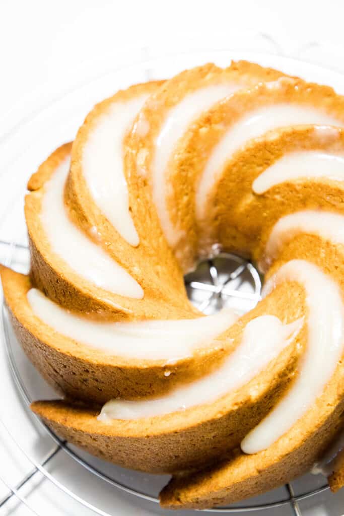 Banana Bundt Cake with Cream Cheese Icing on acooling rack