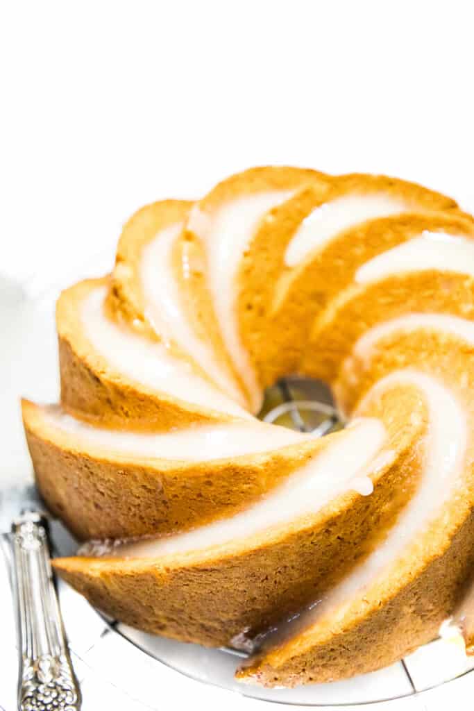 Easy Banana Cake on a cooling rack with a cake slicer next to it.