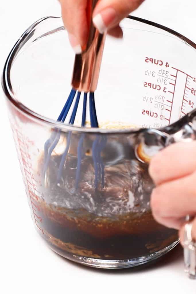 stiring the sauce together with a whisk