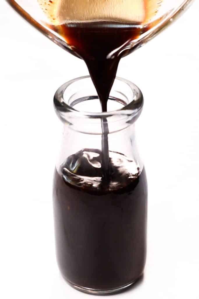 poring the sauce into a bottle