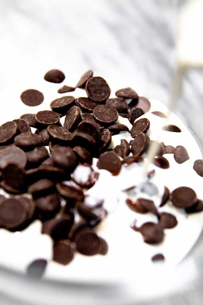 cream pouring over chocolate in a bowl