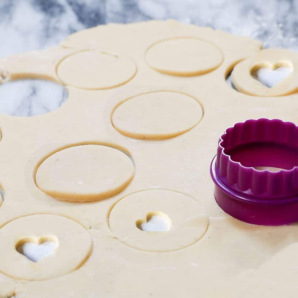 Shapes being cut in dough with a cookie cutter