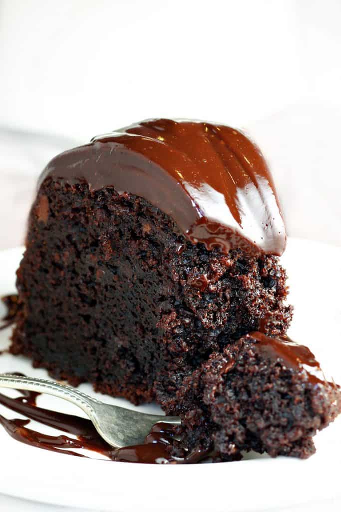 a slice of Chocolate Cake with ganache icing.