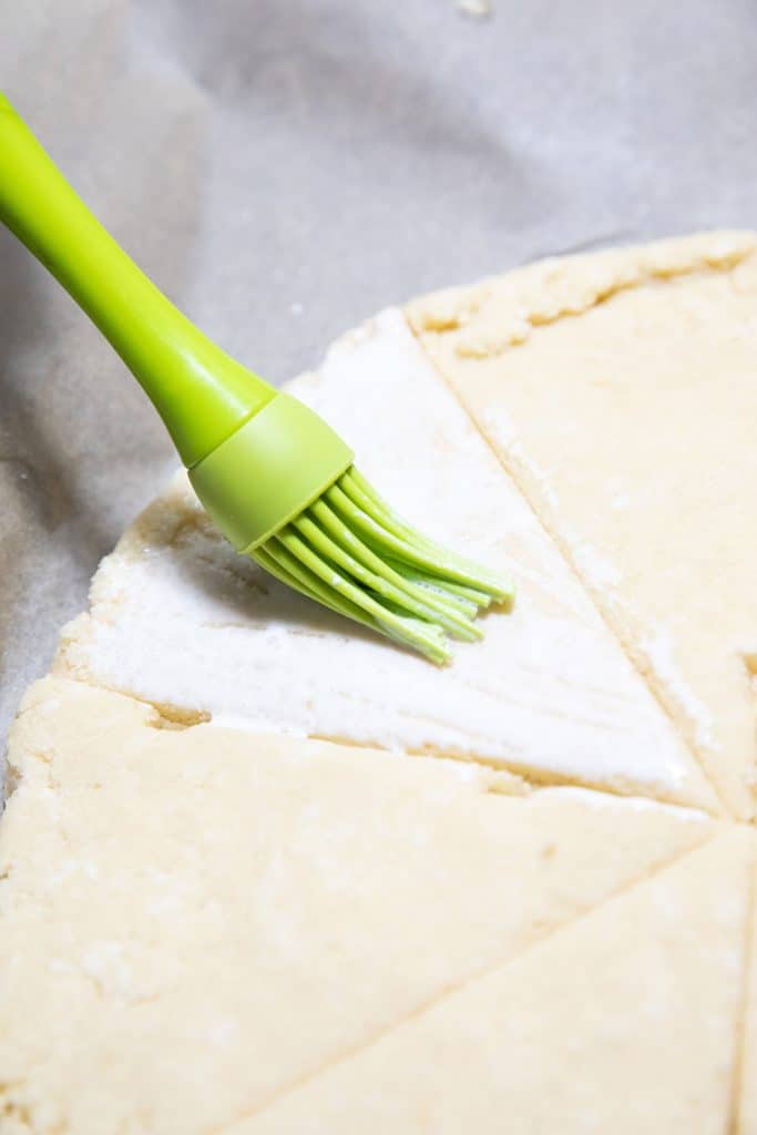 the dough being brushed with cream