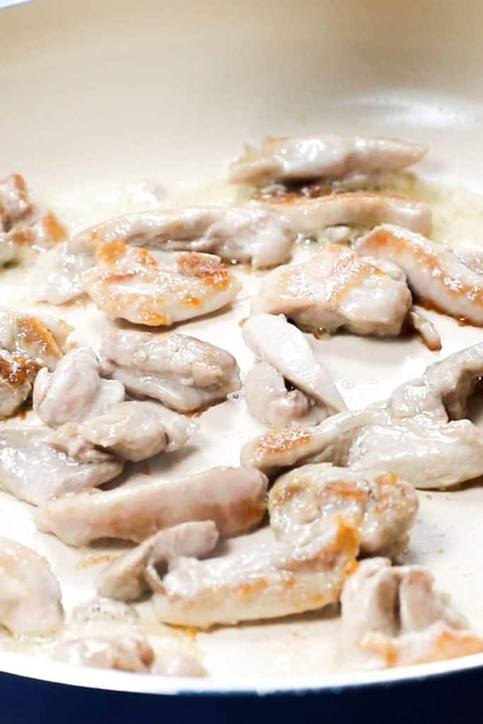 chicken browning in a pan
