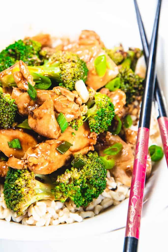 Chocpsticks on a plate with a chicken and broccoli stir-fry