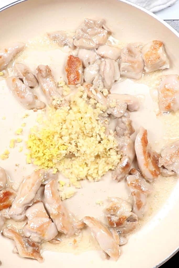 garlic and ginger added to the pan with the chicken
