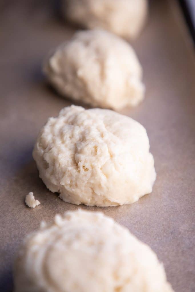raw biscuit dough on a baking sheet