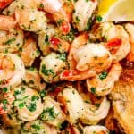 Close up of Shrimp with garlic and parsley piled high in a dish