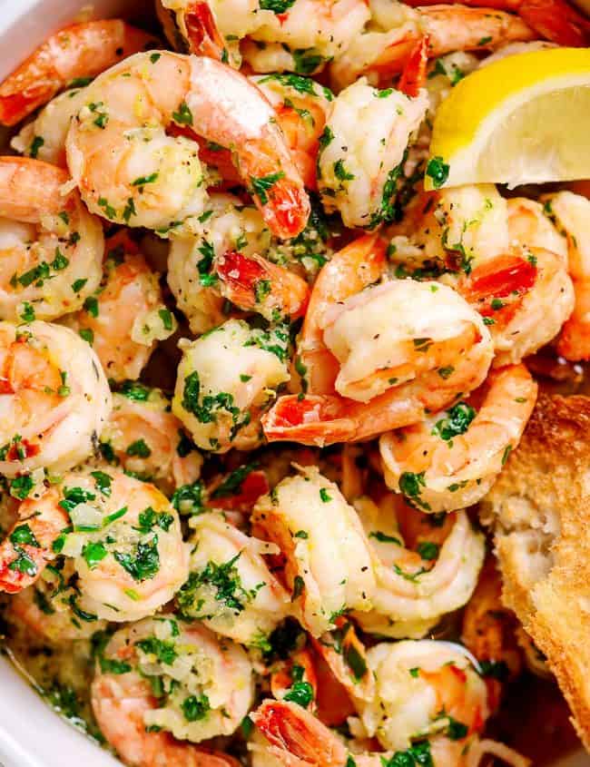 Close up of Shrimp with garlic and parsley piled high in a dish