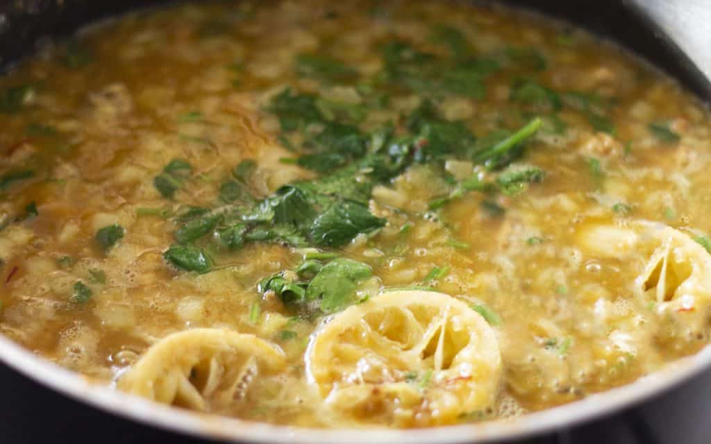 the sauce simmering in a pan