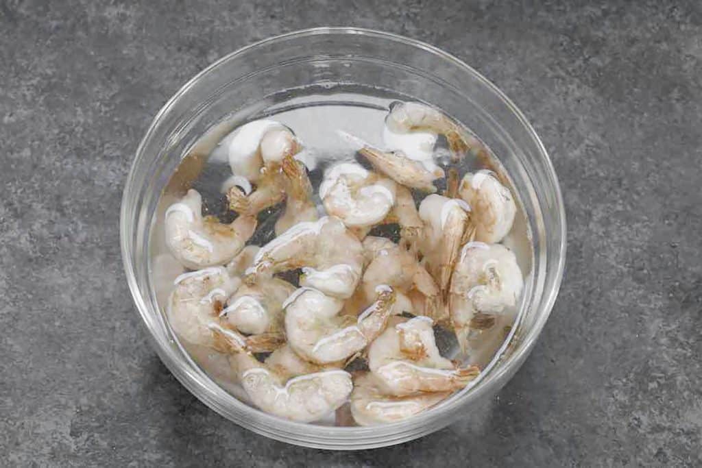 frozen shrimp in a bowl of water