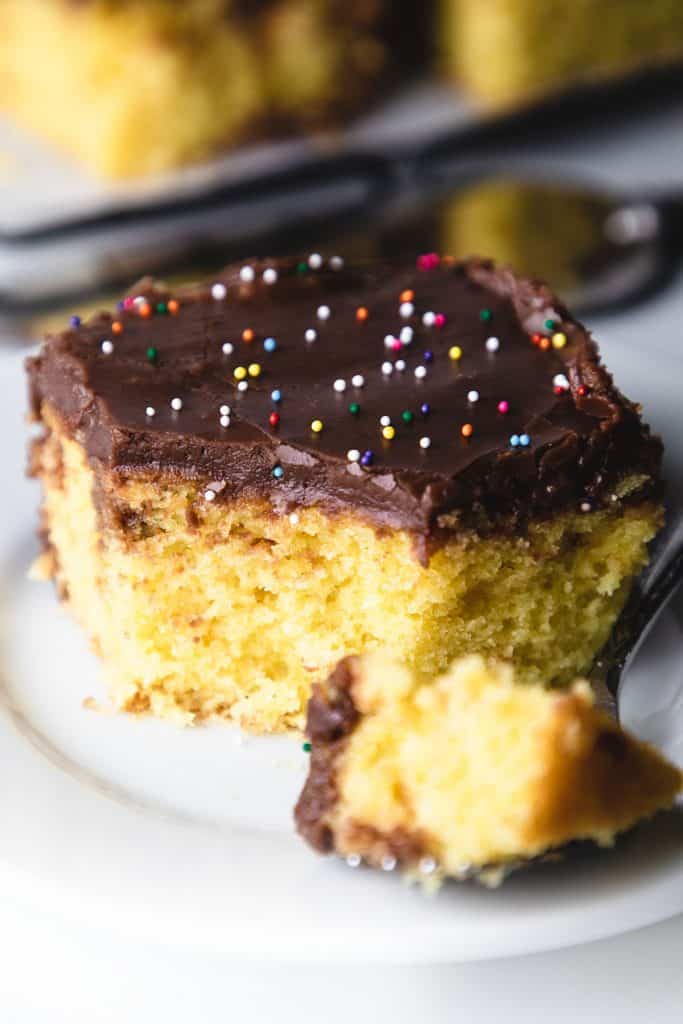 a slice of cake with a bite sized piece next to it