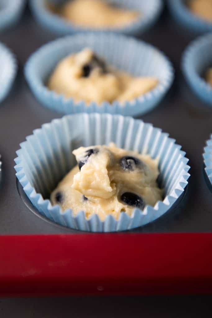 the buttermilk blueberry muffins in cases ready to go in the oven