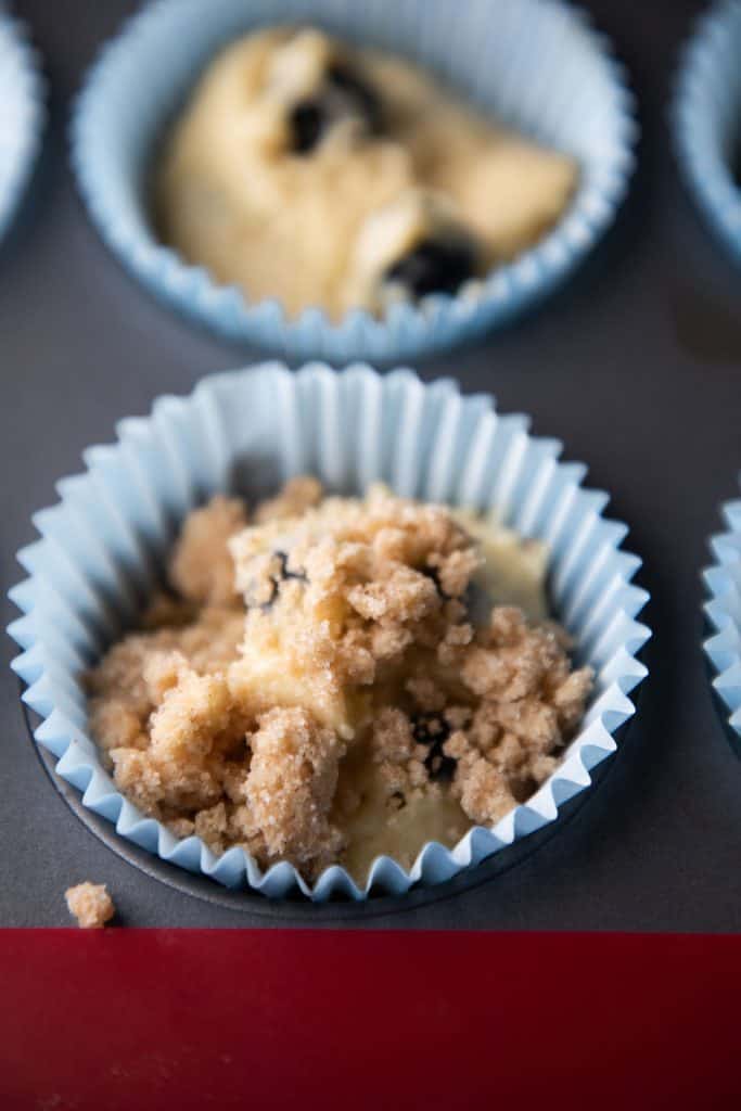crumb topping added to the buttermilk blueberry muffin batter in cake cases
