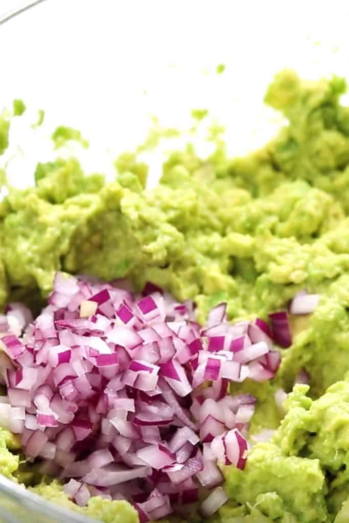 diced red onion added to mashed avocado