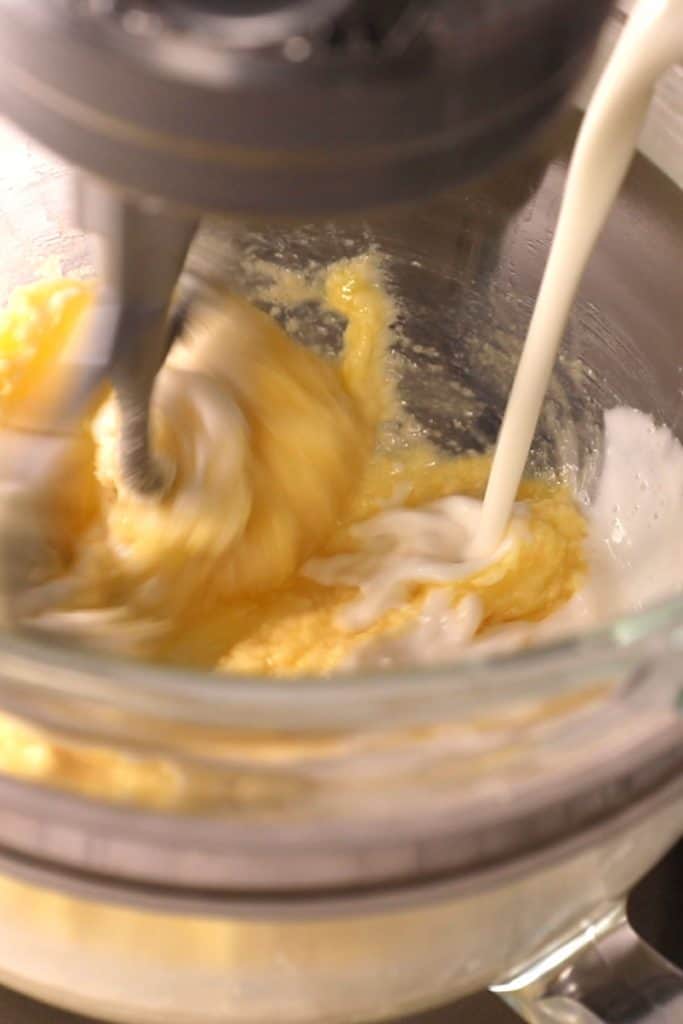 buttermilk being added to the batter in the bowl