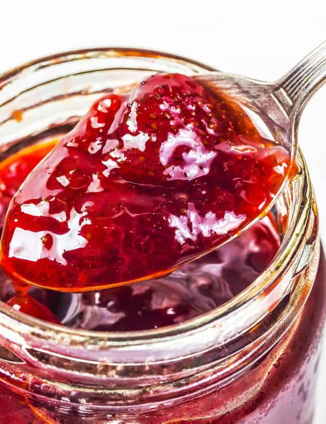 Jar of Strawberry Jam Preserves being spooned out