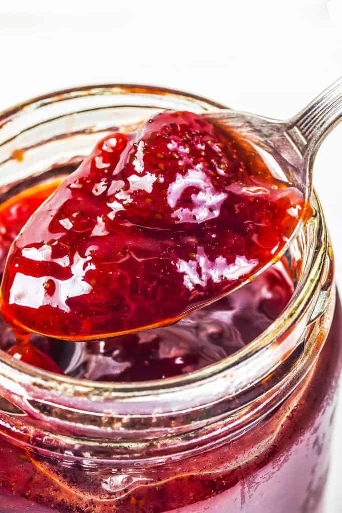 Jar of Strawberry Jam Preserves being spooned out