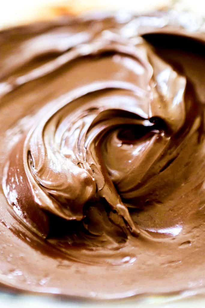 a close up of chocolate frosting in a bowl