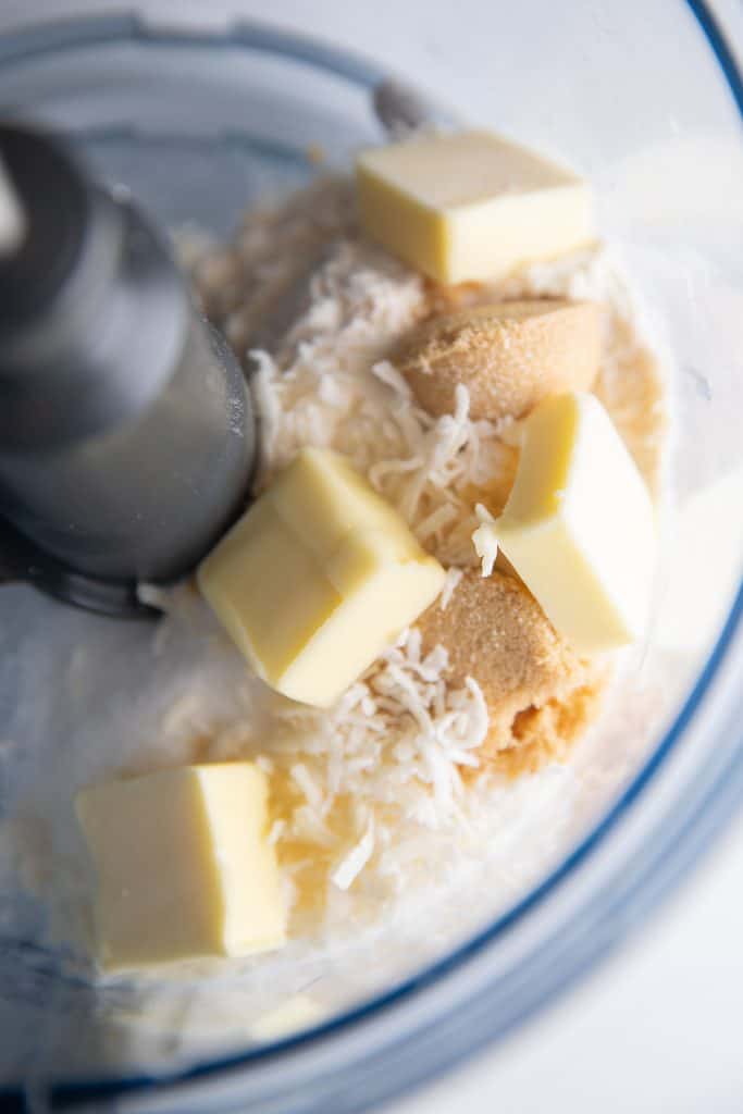 cubes of butter in a mixer with flour and sugar