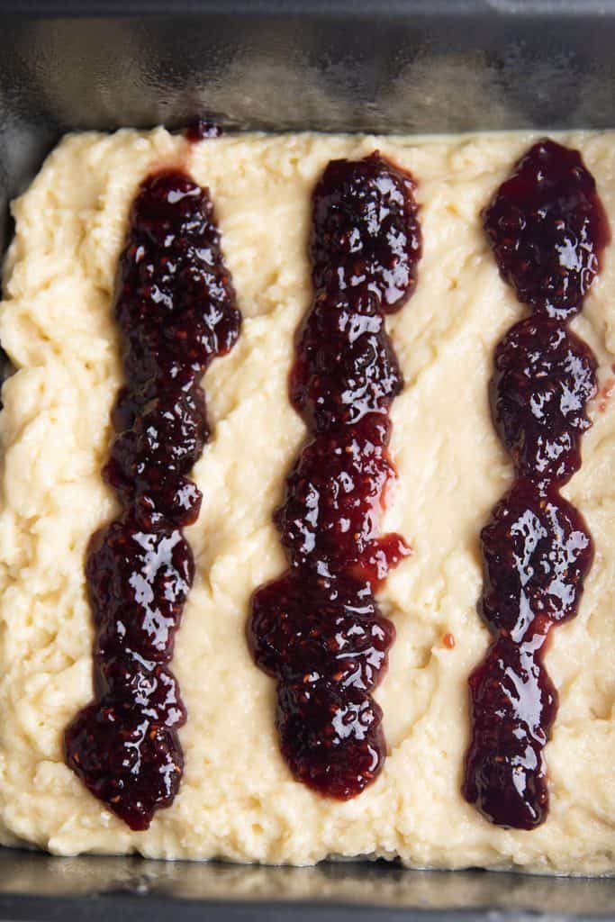 jam drizzled in lines over the uncooked cake