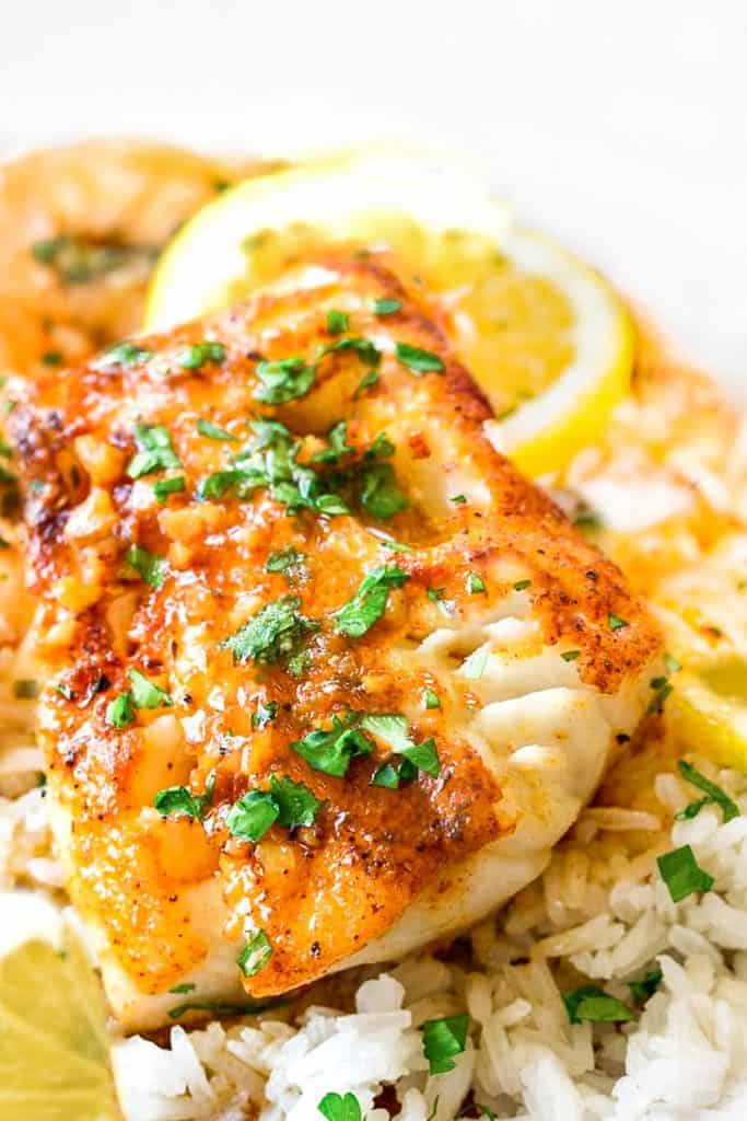 cod in garlic butter sauce with lemon slices