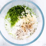 All of the ingredients for the crema sauce in a glass bowl.