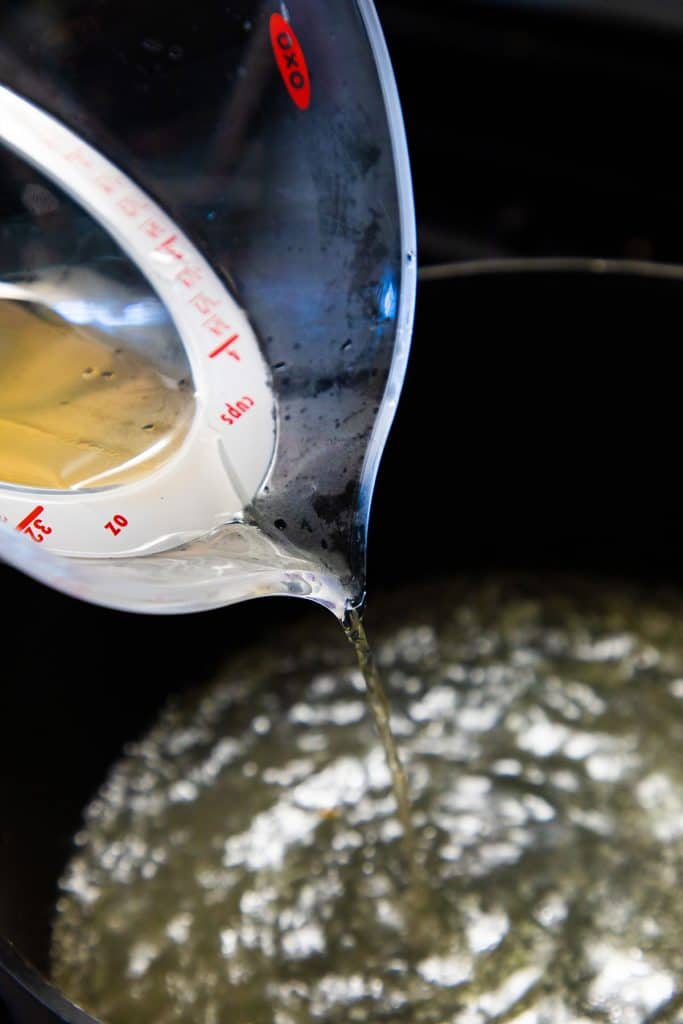 stock being poured into a pan