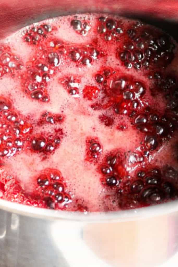 Raspberry Jam Preserves boiling in a pot