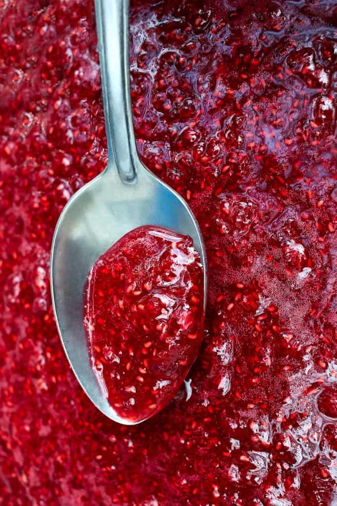 a spoon in a pan of cooking jam