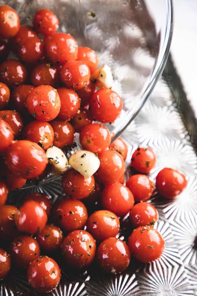 oil being poured onto cherry tomatoes