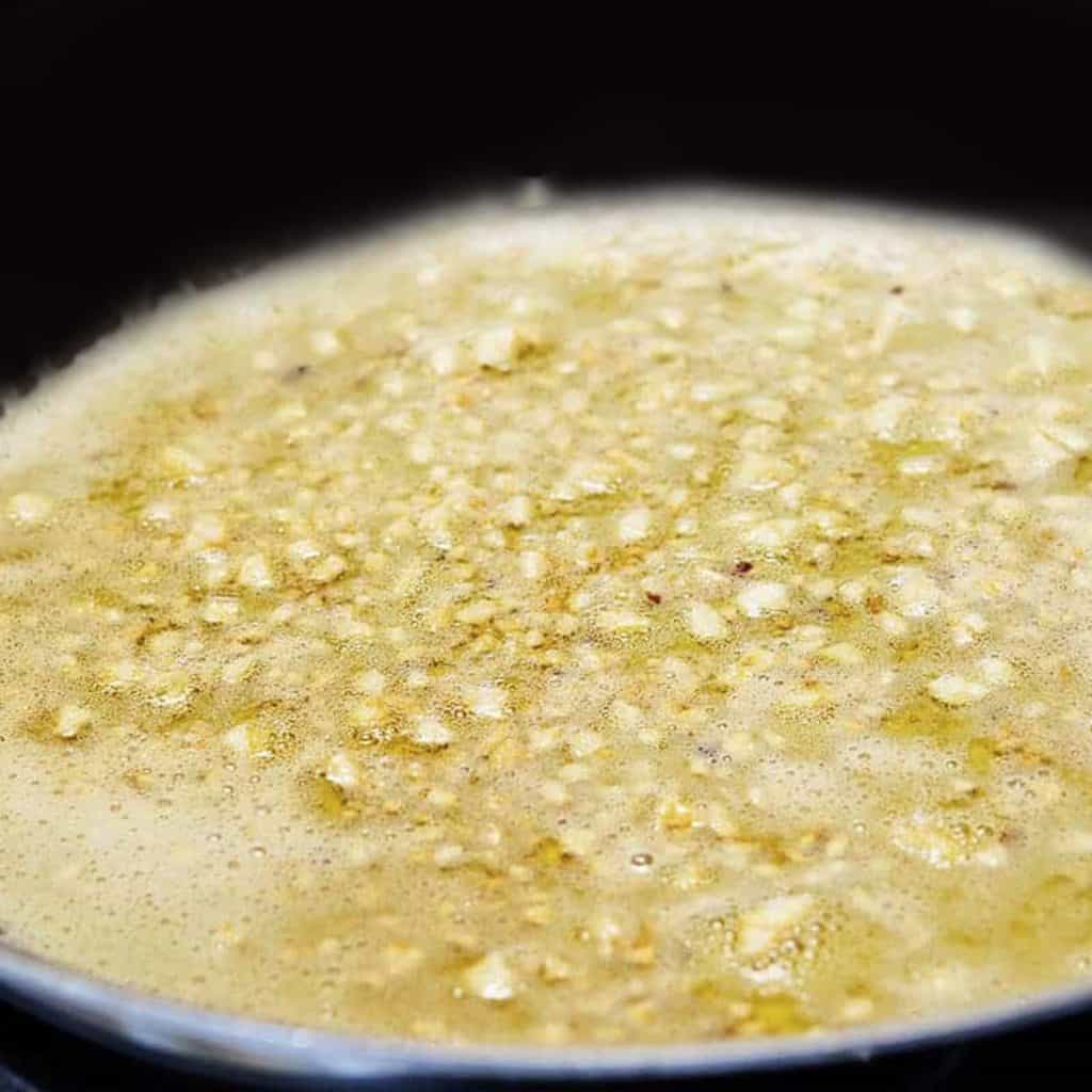 garlic sauteeing in a pan