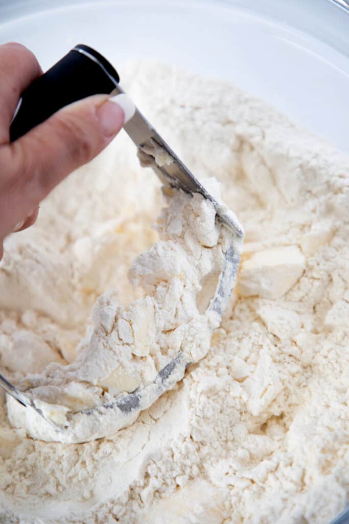 butter being cut into flour