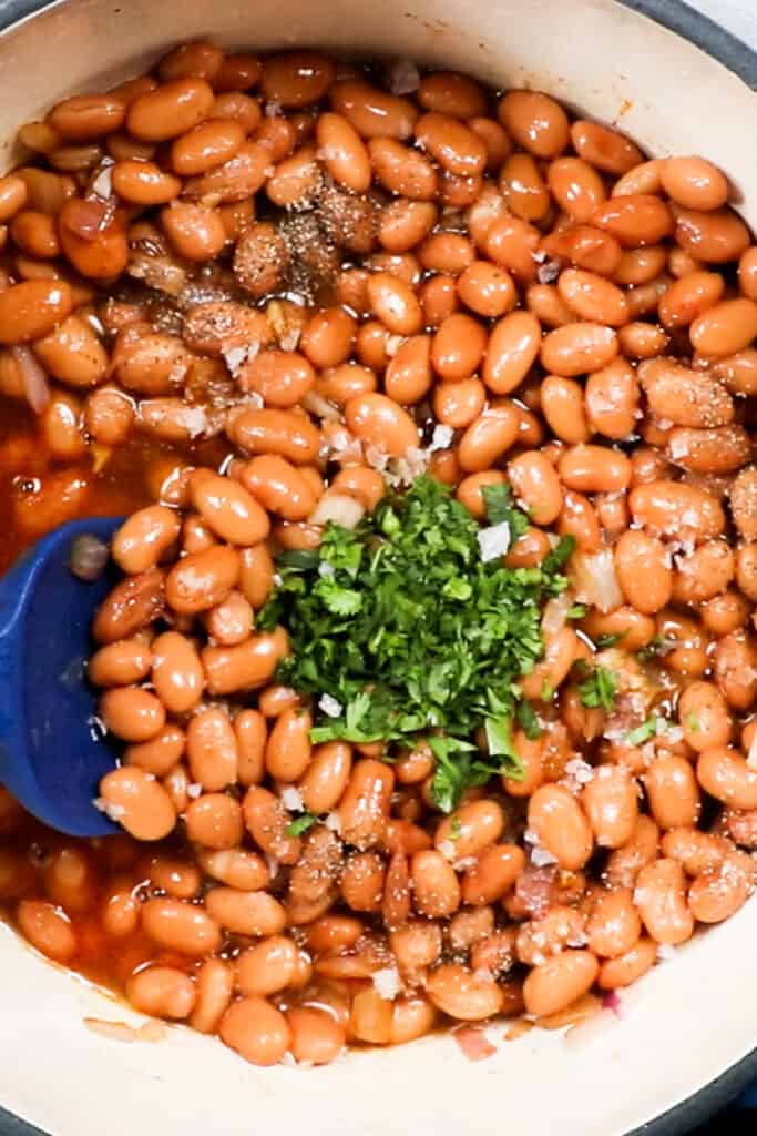 beans, stock and herbs added to the pot